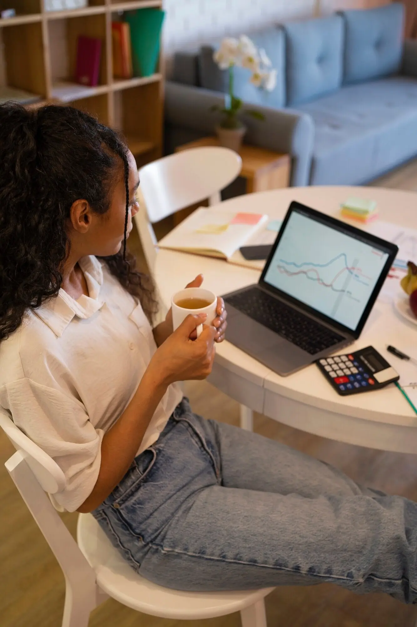 High-angle view of a woman working on a laptop.
